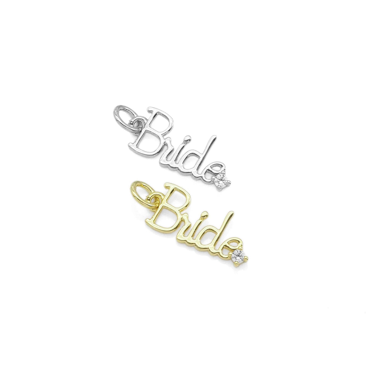 Two script 'Bride' nameplate pendants on a plain white background, one in silver and one in yellow gold, each with a small clear stone accent.