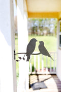 Highland Ridge handmade metal love birds statue with natural rust patina in a garden setting
