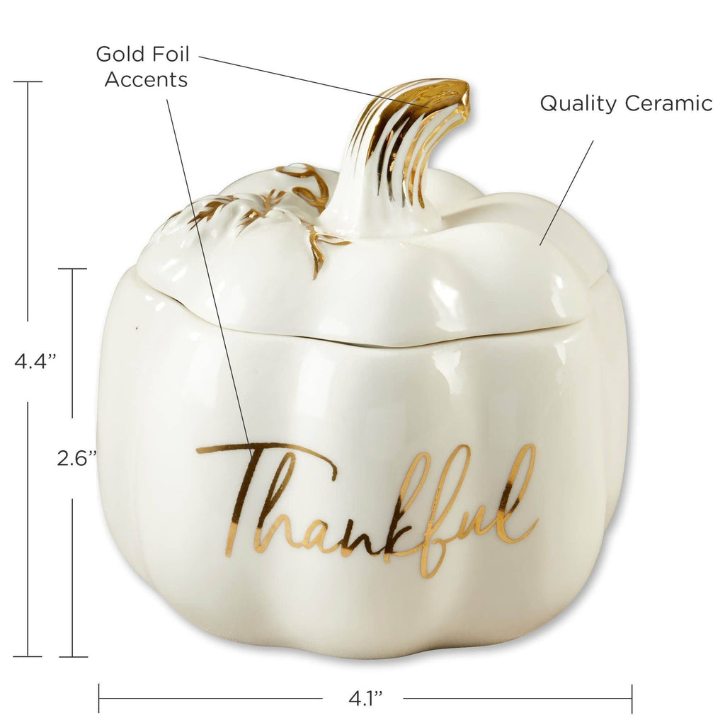 A white ceramic pumpkin-shaped container with a lid and gold foil accents, including the word 'Thankful' in script. The image includes dimension lines and labels showing the product's height and width on a white background.