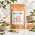 Matcha kraft bag with Sweet Spot Gift Shop label, marble surface with bamboo whisk and matcha powder
